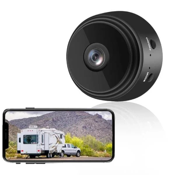 Black security camera with a smartphone displaying a video feed of an RV and truck in a desert landscape.