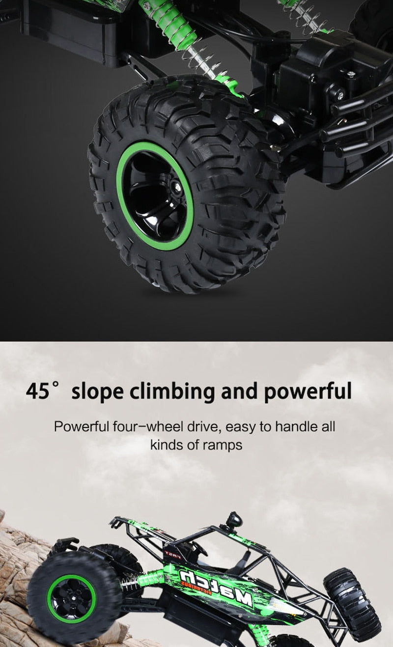 Green off-road vehicle with large black tires on a gray background