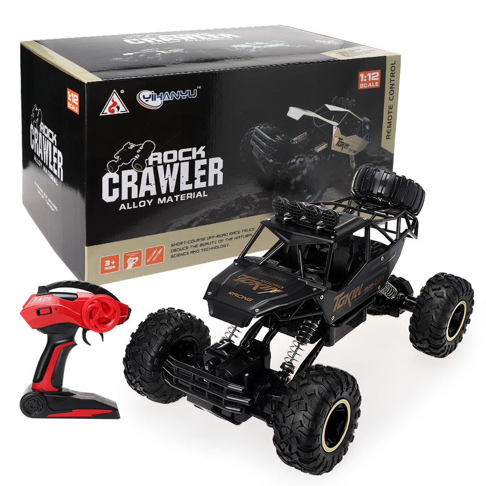 Black remote control rock crawler toy with red remote and packaging on a white background