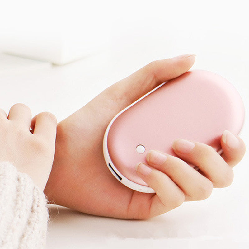 Hand holding a pink handheld  on a white background