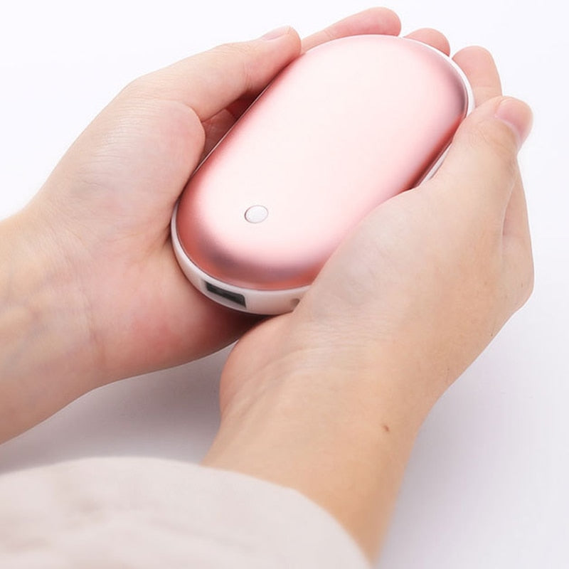 Pink handheld device held in a hand against a white background