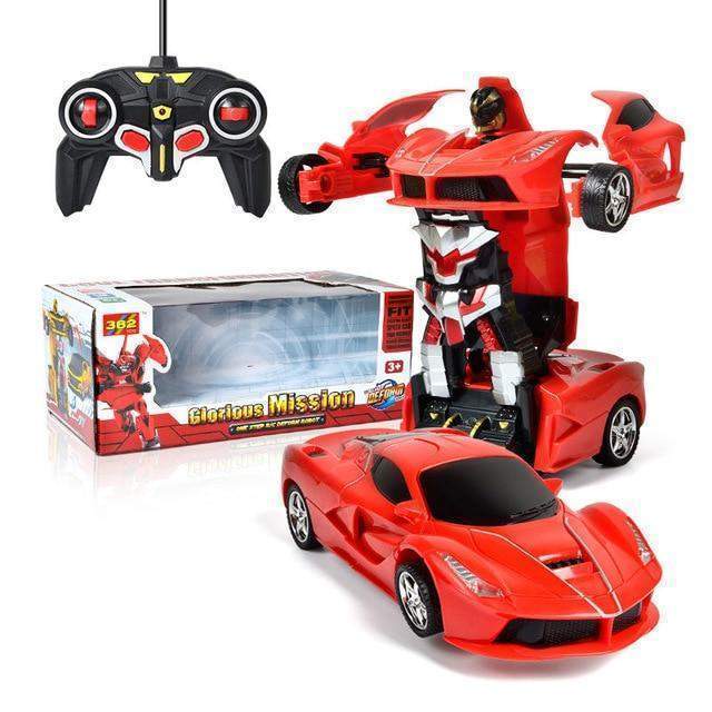 Red toy car transforming into a robot with remote control and packaging on a white background