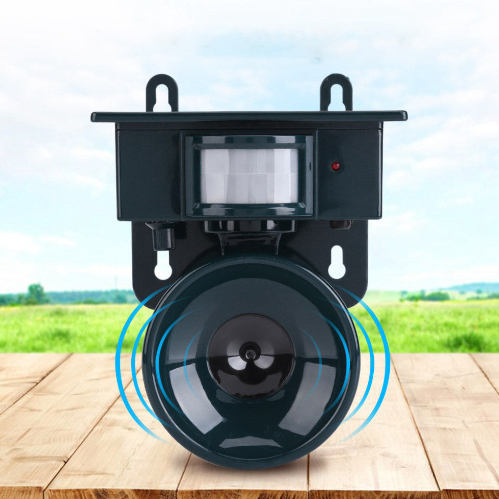 Outdoor security camera with motion sensor on a wooden surface with a scenic background