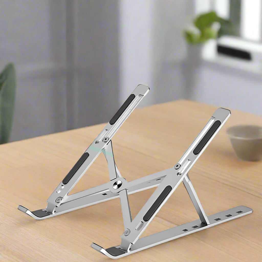 Laptop on a adjustable stand with a white background