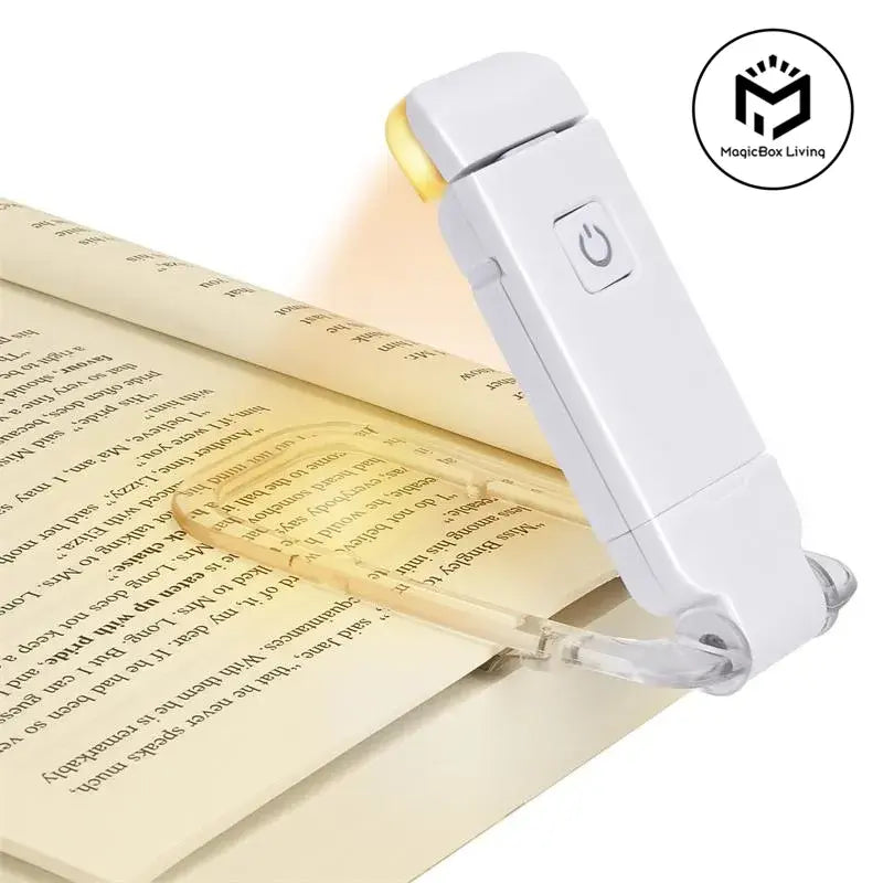 Reading lamp on an open book with MagicBox Living logo