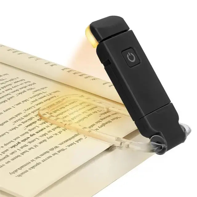 Booklight illuminating a page of a book on a white background