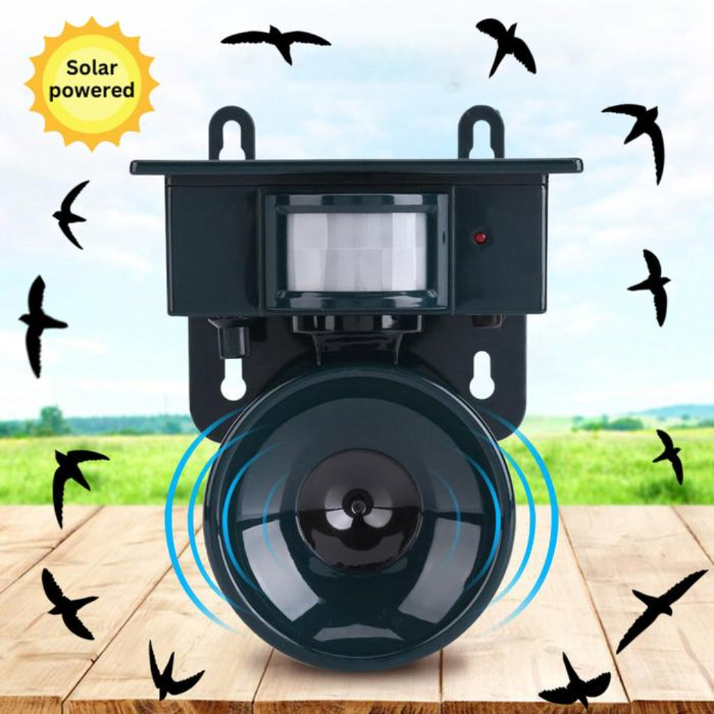 Solar-powered device with a speaker and motion sensor on a wooden surface with birds flying around.