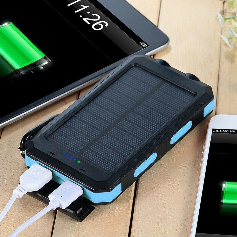 Solar power bank with two USB ports charging devices on a wooden surface