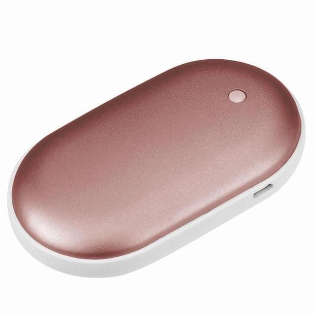 Rose gold oval-shaped handheld warmer on a white background