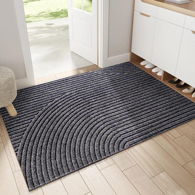 Gray doormat on a wooden floor in a home entrance